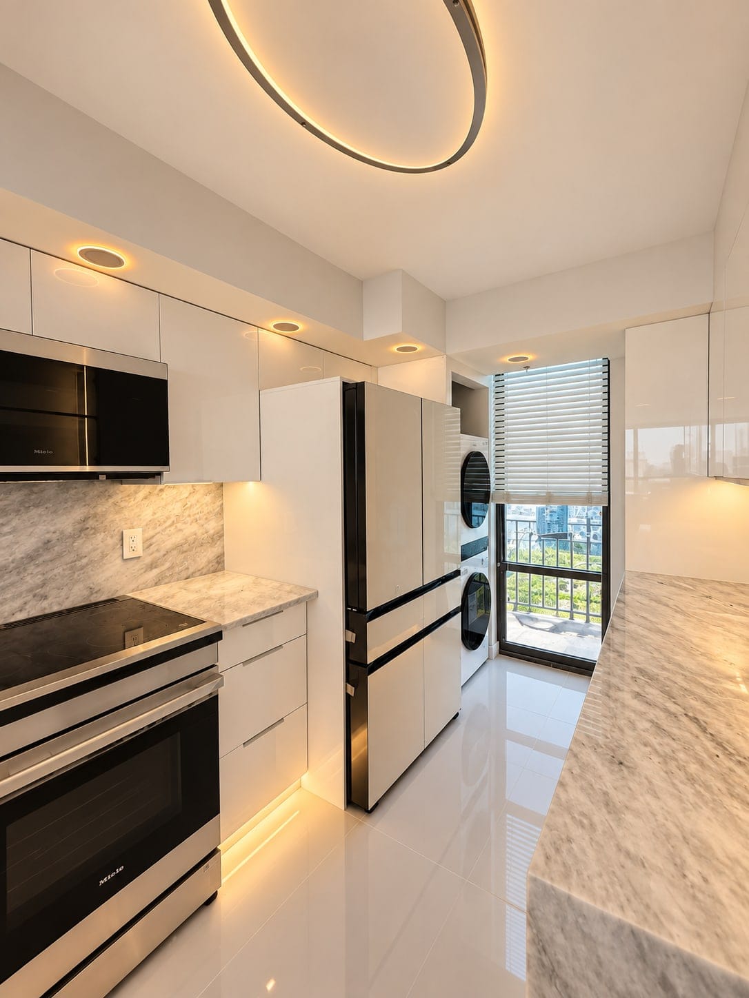 Galley kitchen with white gloss cabinetry and warm under-cabinet light