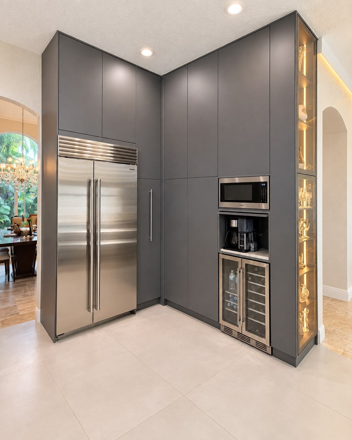 Tall graphite pantry cabinetry around a built-in refrigerator